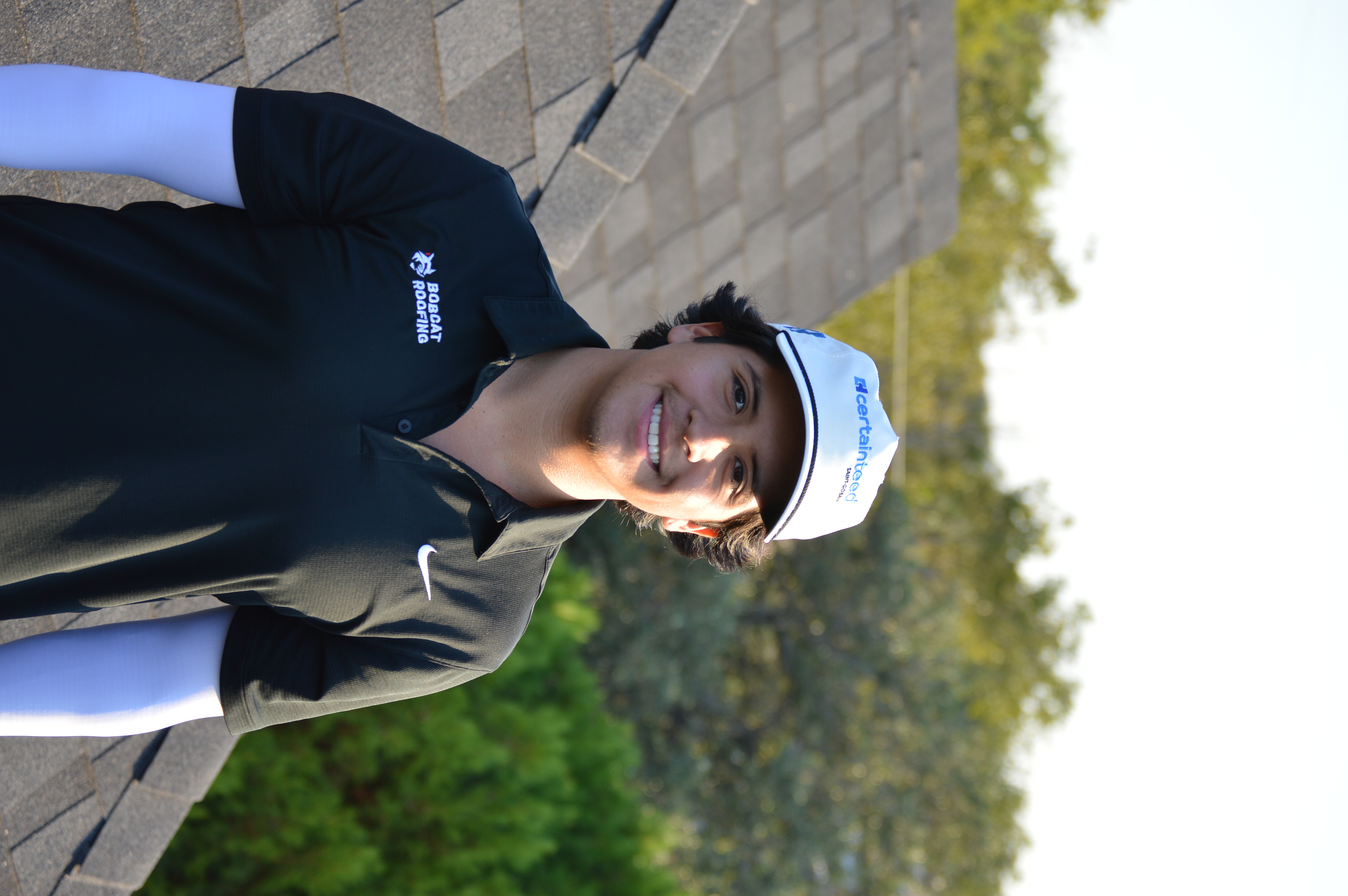 Jay, founder of Bobcat Roofing, standing on a customer's roof